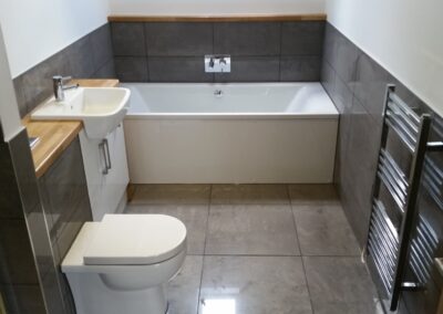 Bathroom design and build with porcelain tiles and bespoke countertop