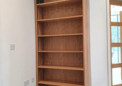 Bespoke solid oak bookcase with adjustable shelving and clear lacquer finish