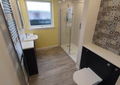 Contemporary shower room with fitted vanity and W.C. cupboards