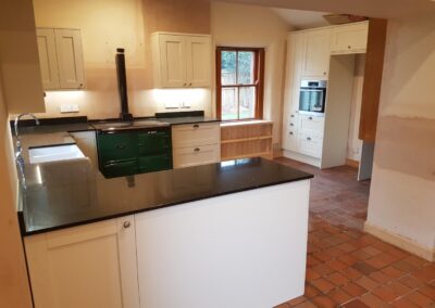 Fitted kitchen with quartz worktops and custom under window storage