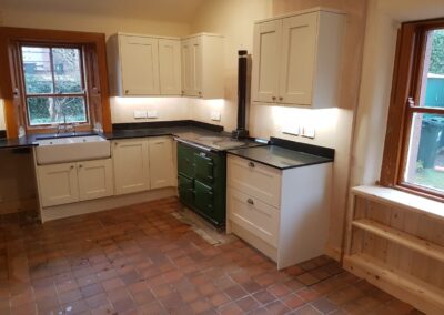 Fitted kitchen with quartz worktops and custom under window storage